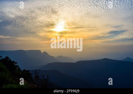 Spectacular silhouette view during sunset in Sahyadri mountain range on a winter evening from Sunset point at Matheran, Maharashtra, India. Stock Photo