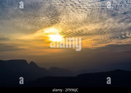 Spectacular silhouette view during sunset in Sahyadri mountain range on a winter evening from Sunset point at Matheran, Maharashtra, India. Stock Photo