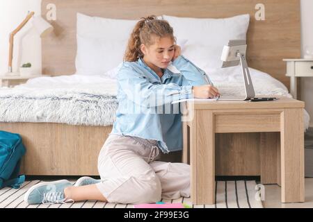 Female student studying online at home Stock Photo