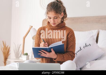 Female student studying online at home Stock Photo