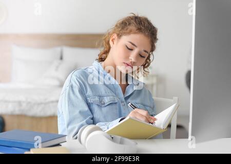 Female student studying online at home Stock Photo