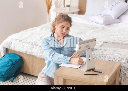 Female student studying online at home Stock Photo