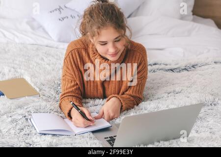 Female student studying online at home Stock Photo
