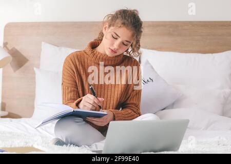 Female student studying online at home Stock Photo