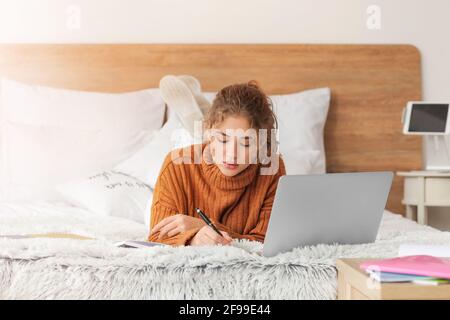 Female student studying online at home Stock Photo
