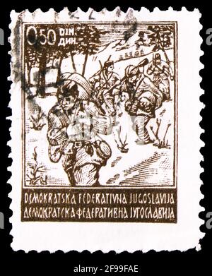 MOSCOW, RUSSIA - NOVEMBER 4, 2019: Postage stamp printed in Yugoslavia shows Partisans on the March, Partisan motifs serie, circa 1945 Stock Photo