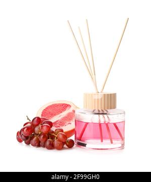 Reed diffuser with grape and grapefruit on white background Stock Photo