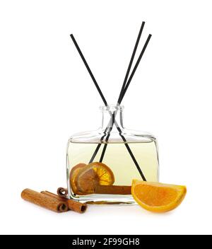 Reed diffuser with cinnamon and orange on white background Stock Photo