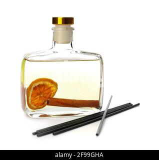 Reed diffuser with cinnamon and orange on white background Stock Photo