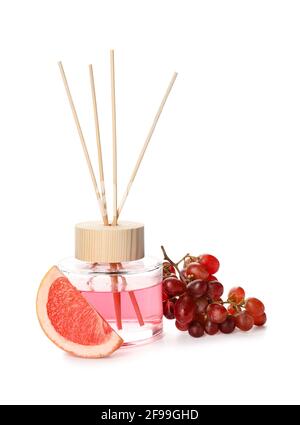 Reed diffuser with grape and grapefruit on white background Stock Photo