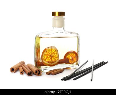 Reed diffuser with cinnamon and orange on white background Stock Photo