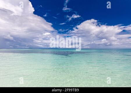 Ocean seascape. Ocean waves with blue sky and clouds, relaxing tropical sea lagoon. Blue sky with light clouds, turquoise ocean with surf, ecology Stock Photo