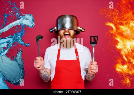 Man chef is ready to fight in the kitchen. burgundies background Stock Photo