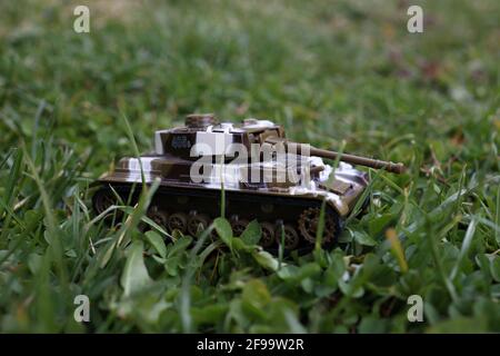 Plastic toy armor stands in the grass. Stock Photo