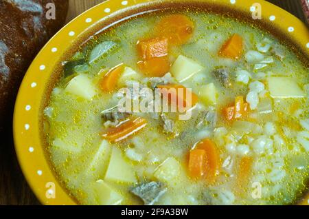 Krupnik zupa -  thick Polish soup made from vegetable or meat broth, containing potatoes and barley groats Stock Photo