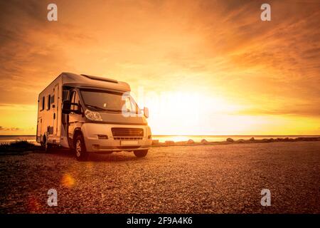 Motorhome at sunset on the beach Stock Photo