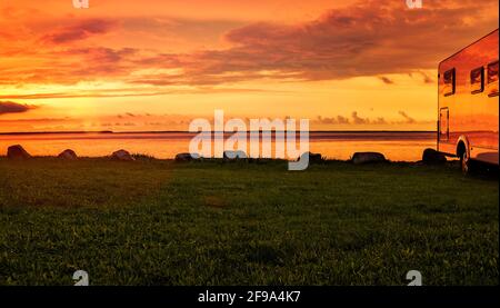 Motorhome at sunset on the beach Stock Photo