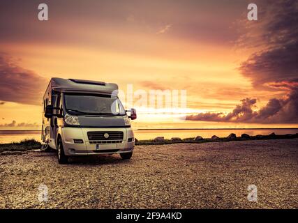 Motorhome at sunset on the beach Stock Photo