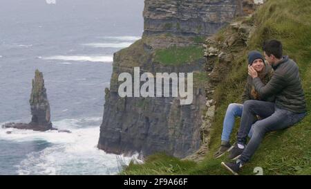 Two friends in love at the Cliffs of Moher in Ireland - breathtaking scenery