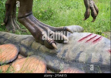 Allosaurus with dead stegosaurus, dinosaur models in Dinopark Münchehagen near Hanover. Stock Photo