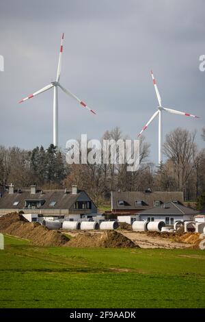 Juchen, North Rhine-Westphalia, Germany - Sewer construction in a new housing estate in front of the wind farm at the RWE open-cast lignite mine in Garzweiler. Stock Photo