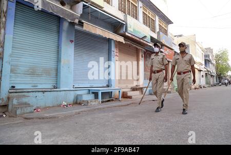 Beawar, Rajasthan, India, April 16, 2021: Police personnel patrol at a market area during weekend curfew imposed by state government, amid surge in coronavirus cases across the country, in Beawar. Credit: Sumit Saraswat/Alamy Live News Stock Photo