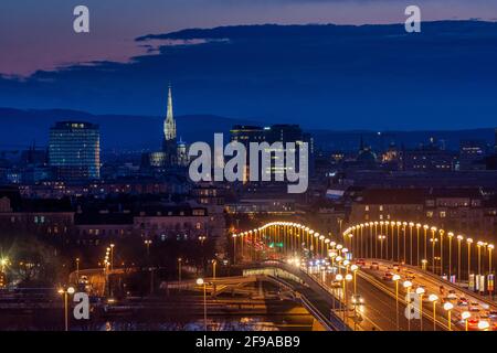 Vienna, Vienna city center, river Donau (Danube), bridge Reichsbrücke, road car traffic, cathedral Stephansdom (St. Stephen's Cathedral), Uniqa Tower with media facade with a dot matrix of LEDs in 00. overview, Wien, Austria Stock Photo