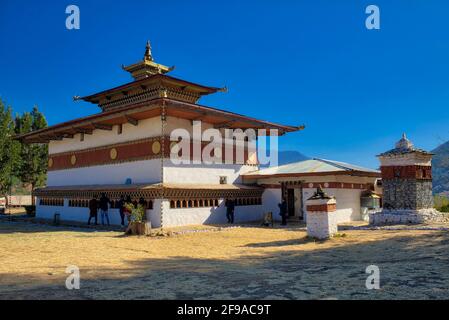 The temple of Chimi Lhakhang in Bhutan is elegantly designed with brown and golden roof and the white walls which are adorned with gold medallions. Th Stock Photo