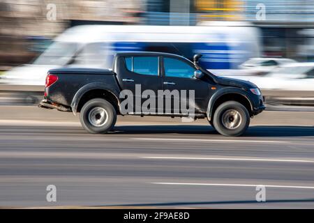 Ukraine, Kyiv - 3 March 2021: Black Mitsubishi L200 car moving on the street; Stock Photo