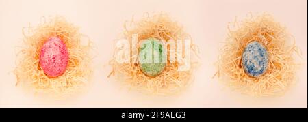 Brightly colored Easter eggs in an Easter basket isolated on a white background Stock Photo