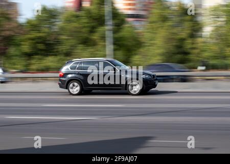 Ukraine, Kyiv - 24 September 2020: Black and red cars moving on the street Stock Photo