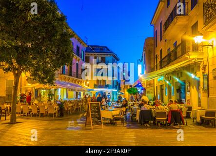 ALCUDIA, SPAIN, MAY 23, 2017: Sunset view of a narrow street in the old town of Alcudia, Mallorca, Spain Stock Photo