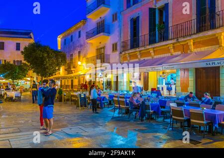 ALCUDIA, SPAIN, MAY 23, 2017: Sunset view of a narrow street in the old town of Alcudia, Mallorca, Spain Stock Photo