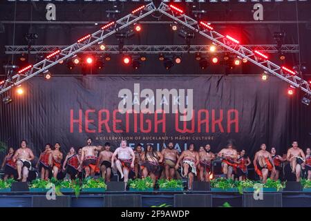 A group of New Zealand Maori men and women perform a haka on stage during the Tamaki Herenga Waka Festival of Maori culture, Auckland, New Zelaand Stock Photo