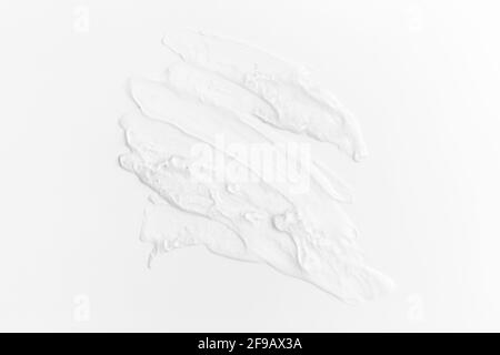 Textures from cosmetics. Smears from transparent aloe vera cream on white table Stock Photo