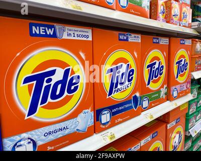 "RAK, RAK, United Arab Emirates - 4.17.2021.: Orange Tide laundry detergent boxes lined up for sale in a store shelf in the grocery store." Stock Photo