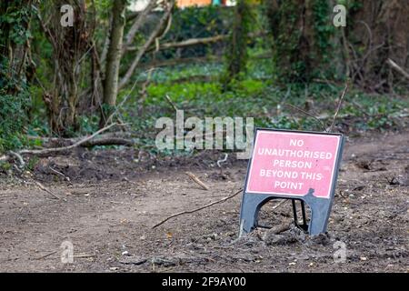 A No access sign next to a forest path Stock Photo