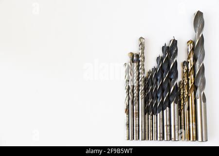 Closeup shot of different sizes of drill bits isolated on white background Stock Photo
