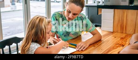 Mother and daughter drawing together Stock Photo