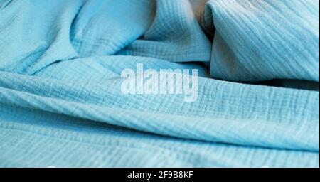Blue muslin background. Cotton clothing and textiles. Natural organic fabrics. Stock Photo