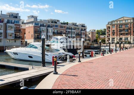 Yachts in a marina surrounded by modern apartment buildings on a sunny autumn day Stock Photo