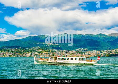 LUGANO, SWITZERLAND, JULY 25, 2017: Passenger ferry is arriving to the pier at port at Lugano, Switzerland Stock Photo