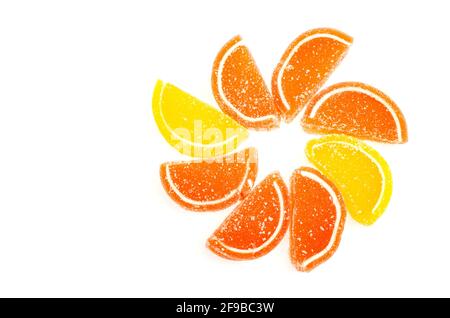 Orange and yellow slices of sweet fruit marmalade in sugar isolated on white background. Studio Photo Stock Photo