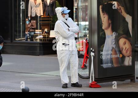 Street cleaner wearing protective apparel in Milan Stock Photo