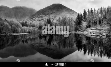 Beautiful  black and white landscape image of Torren Lochan in Glencoe in Scottish Highlands on a Winter day Stock Photo