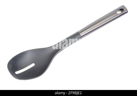 Plastic culinary black spoon, slotted spatula, kitchen gadget. Kitchen utensil. Isolated. Studio Photo Stock Photo