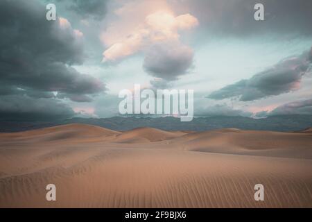 Sand shifts and rises into dunes at Mesquite Flats in Death Valley, California.