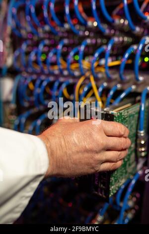 Close-up of unrecognizable support technician installing blade server in data center Stock Photo