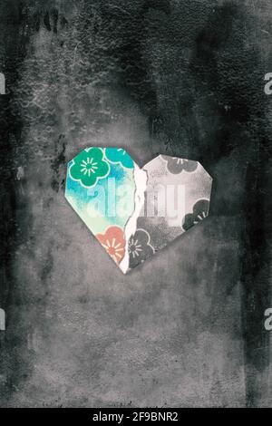 Tore Origami heart floating over black textured background with copy space Stock Photo
