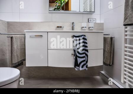 modern vanity unit with base unit and matching accessories. The colors are kept cool in gray and white Stock Photo